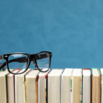 front view books with glasses |